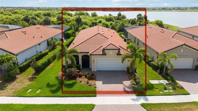 birds eye view of property with a water view