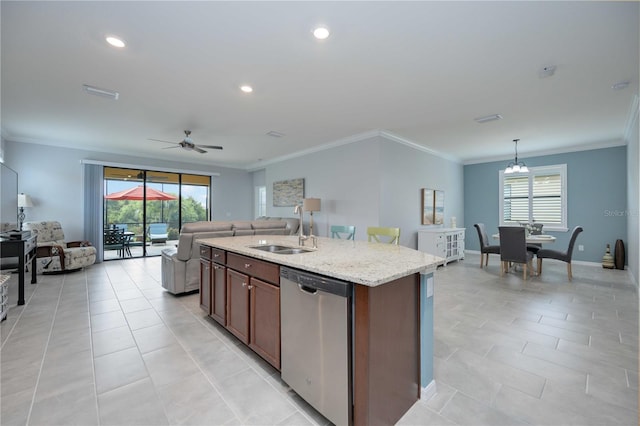 kitchen featuring dishwasher, ceiling fan with notable chandelier, sink, an island with sink, and decorative light fixtures