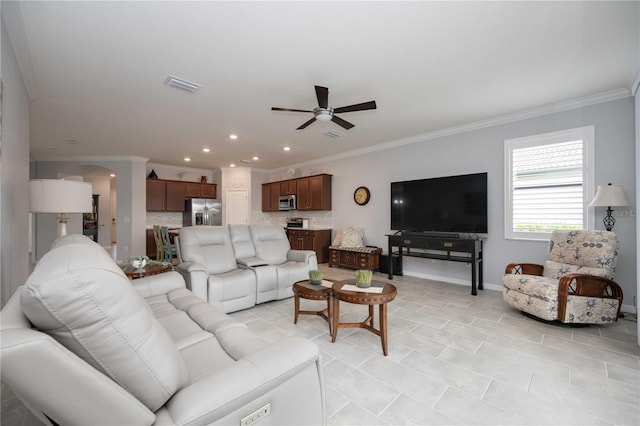 living room with ceiling fan and ornamental molding