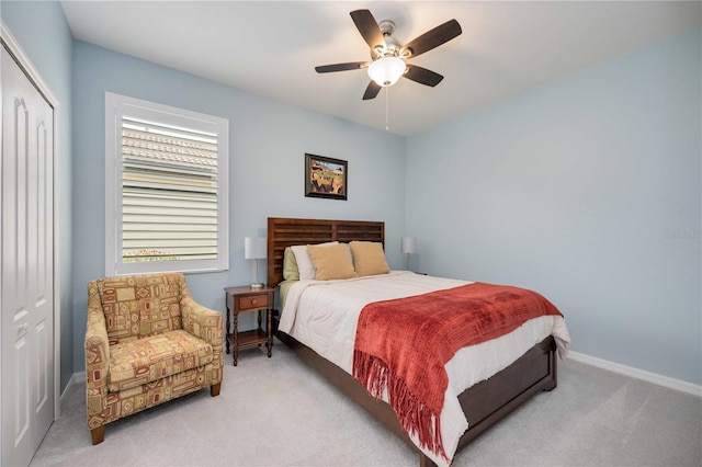 carpeted bedroom with ceiling fan and a closet