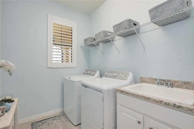 laundry room with sink, cabinets, and independent washer and dryer