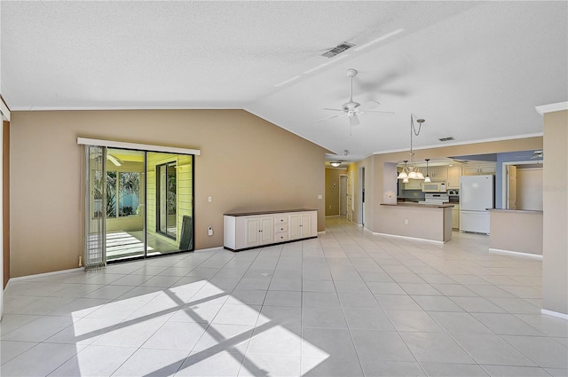 unfurnished living room with ceiling fan, light tile patterned flooring, and vaulted ceiling