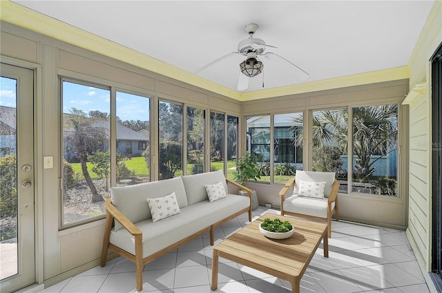 sunroom featuring ceiling fan