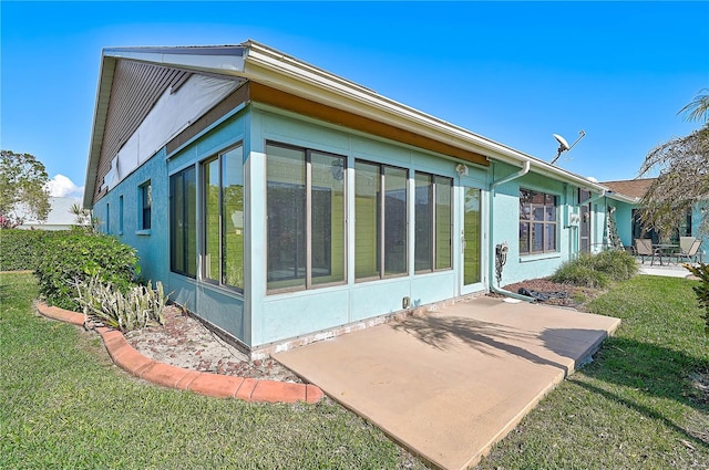 view of property exterior featuring a patio area and a yard