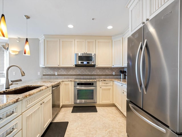 kitchen with decorative backsplash, sink, hanging light fixtures, and appliances with stainless steel finishes