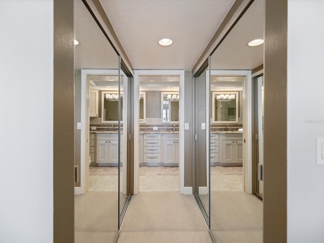 hallway with light colored carpet