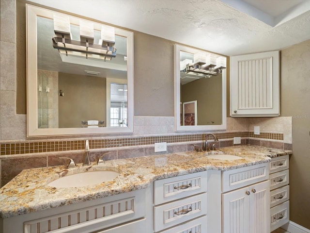 bathroom featuring a textured ceiling and vanity