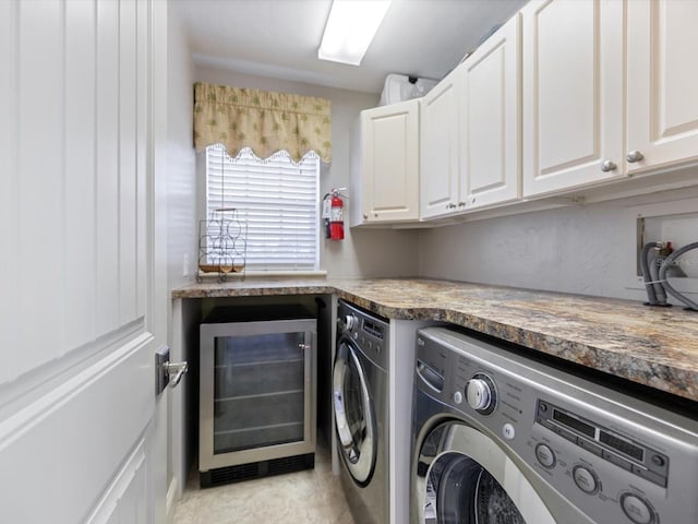 laundry room featuring wine cooler, washer and dryer, and cabinets