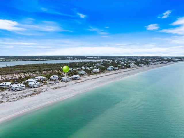 birds eye view of property featuring a water view and a view of the beach