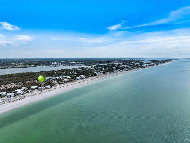 bird's eye view featuring a water view and a beach view