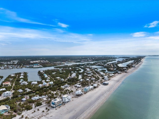 bird's eye view with a water view and a beach view