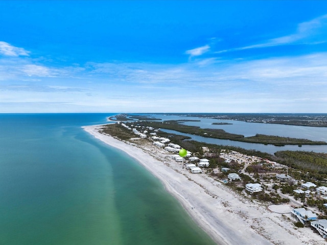 drone / aerial view with a beach view and a water view