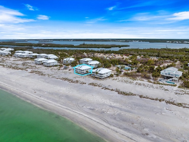 drone / aerial view with a water view and a view of the beach