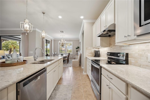 kitchen featuring sink, crown molding, decorative light fixtures, light stone counters, and stainless steel appliances