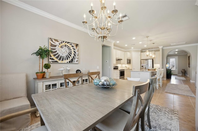 tiled dining space featuring crown molding and a chandelier