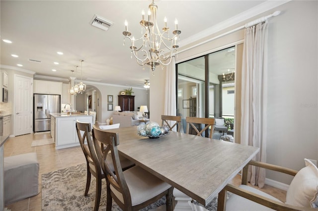 dining room featuring ceiling fan with notable chandelier, crown molding, and light tile patterned flooring