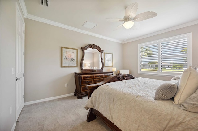 carpeted bedroom featuring ceiling fan and crown molding