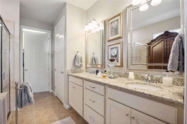 bathroom with tile patterned flooring, vanity, and a shower with door