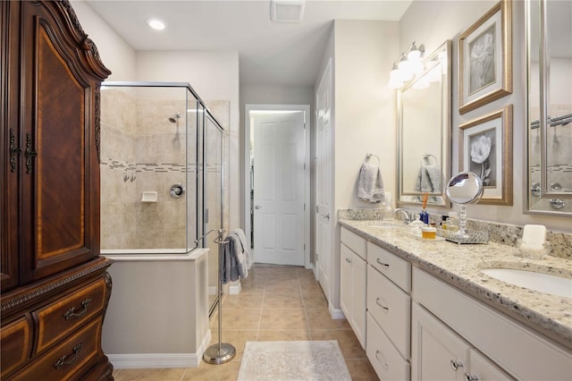 bathroom with tile patterned flooring, vanity, and a shower with door