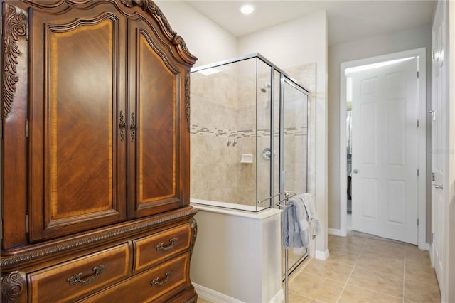 bathroom with tile patterned flooring and a shower with door