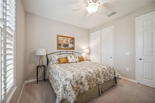 carpeted bedroom featuring ceiling fan and a closet