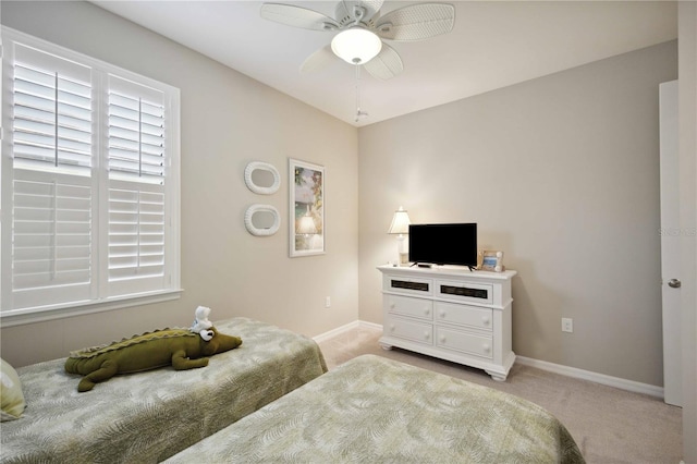 bedroom with ceiling fan and light carpet