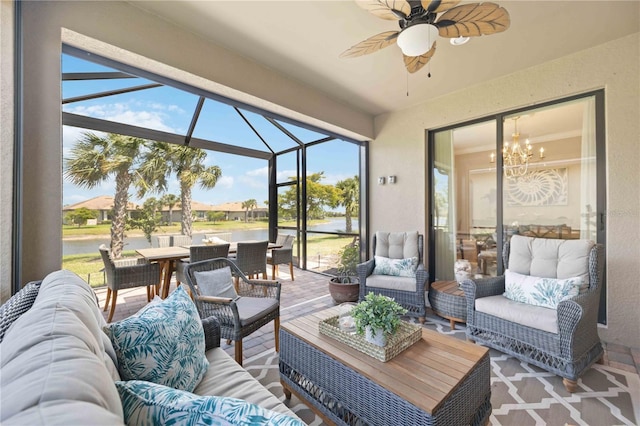 sunroom featuring ceiling fan with notable chandelier