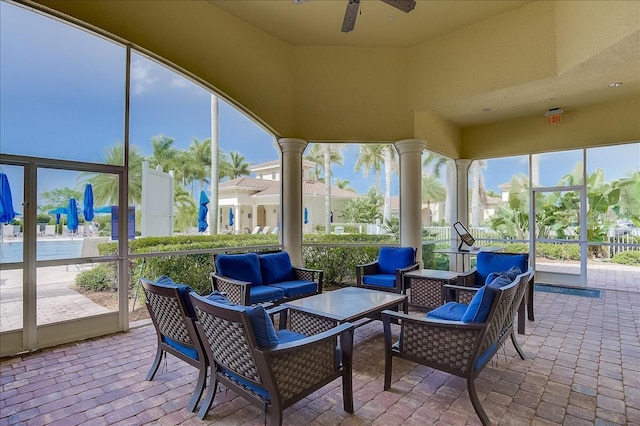 sunroom featuring ceiling fan