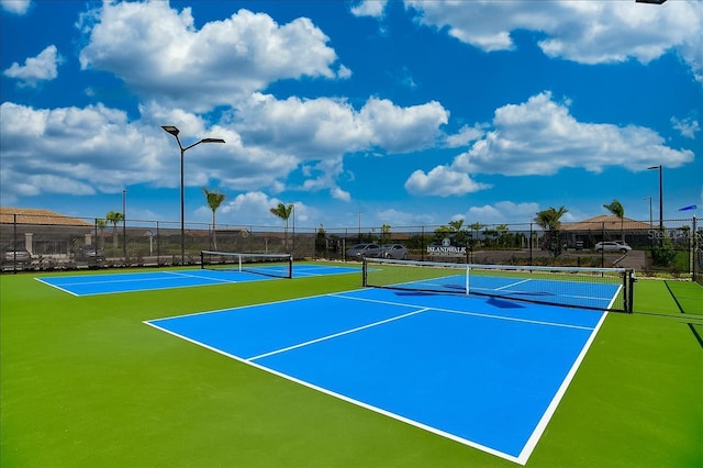 view of tennis court with basketball hoop