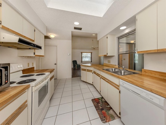 kitchen featuring white cabinetry, white appliances, and sink