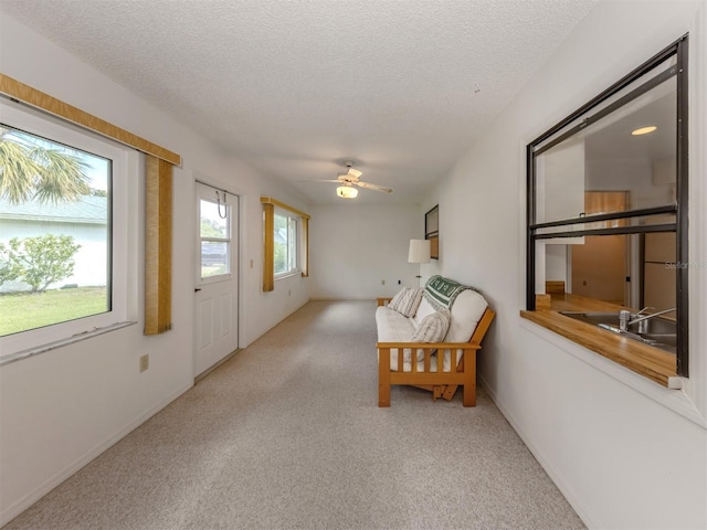 sunroom / solarium featuring ceiling fan