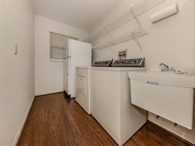 washroom featuring sink, separate washer and dryer, and dark wood-type flooring