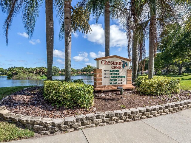 community sign featuring a water view