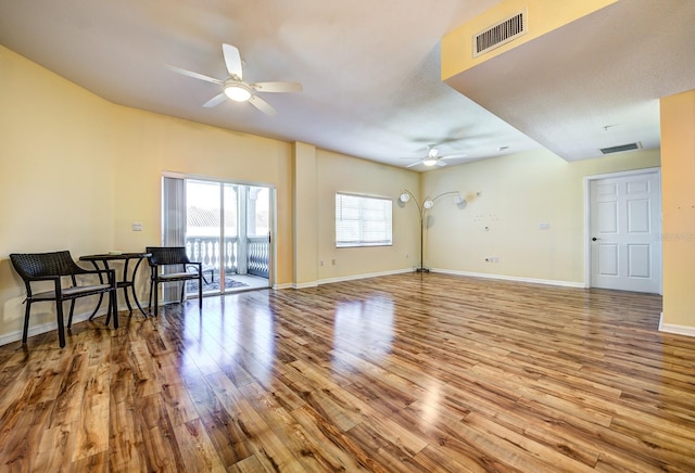 living room featuring light wood-type flooring and ceiling fan