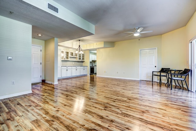 living room with ceiling fan and light wood-type flooring