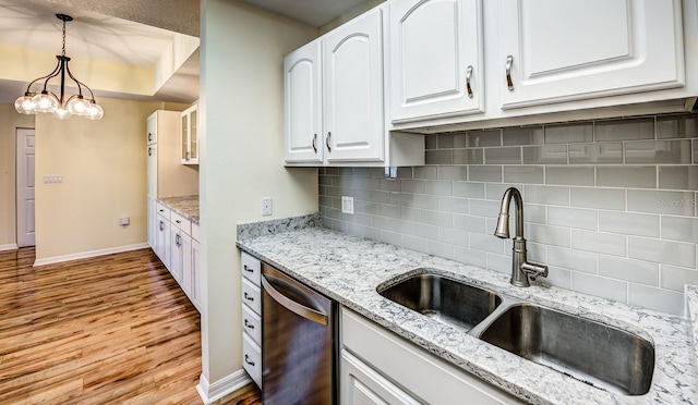 kitchen with white cabinetry, dishwasher, sink, tasteful backsplash, and decorative light fixtures