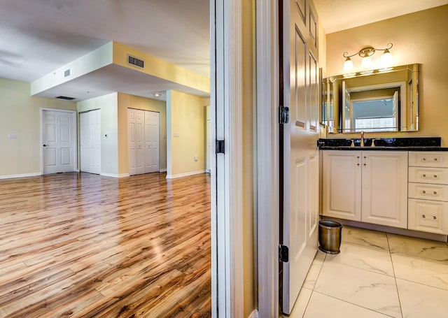 bathroom featuring hardwood / wood-style floors and vanity