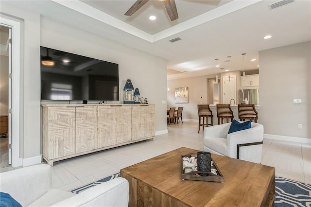 living room featuring ceiling fan and light tile patterned floors