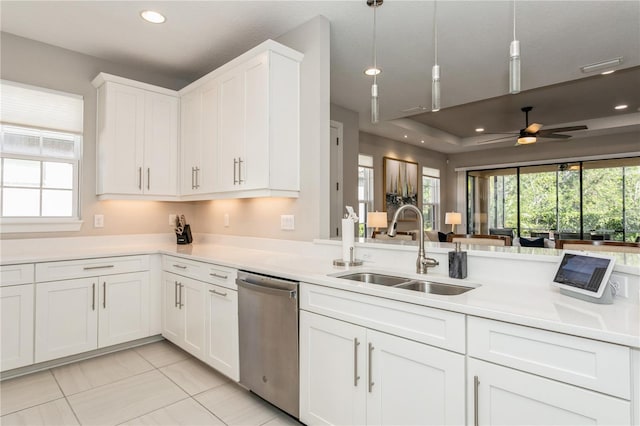 kitchen featuring dishwasher, hanging light fixtures, ceiling fan, sink, and white cabinetry