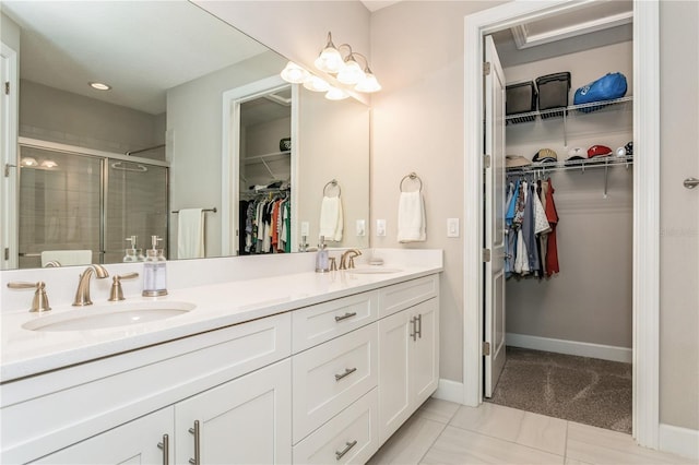 bathroom with an enclosed shower, tile patterned floors, and vanity