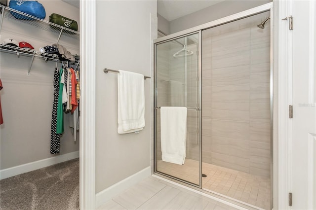 bathroom featuring an enclosed shower and tile patterned floors