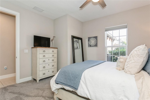 bedroom featuring ceiling fan and light carpet