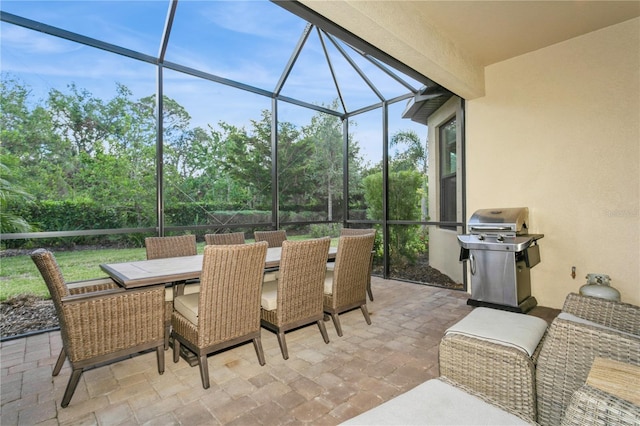 view of patio / terrace with grilling area and glass enclosure