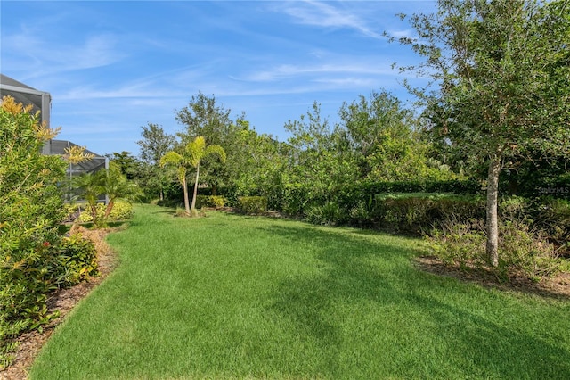 view of yard featuring glass enclosure