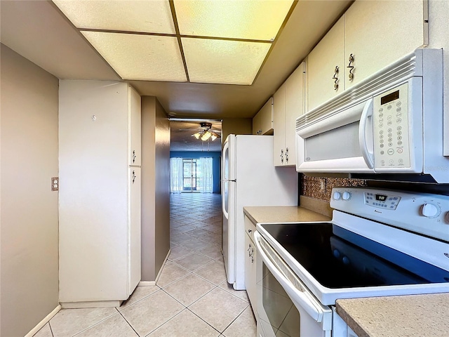 kitchen with ceiling fan, light tile patterned floors, and white appliances