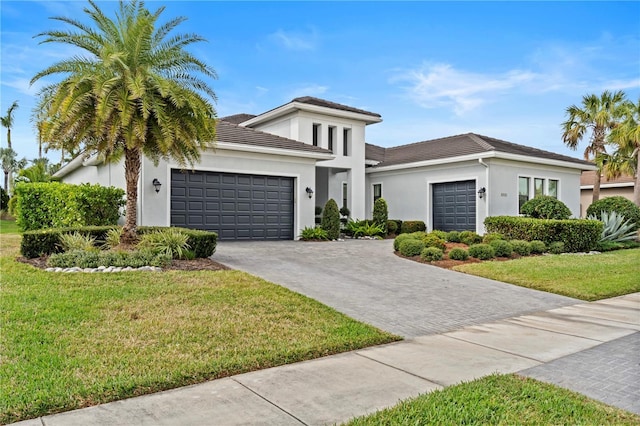 view of front of property featuring a front yard and a garage