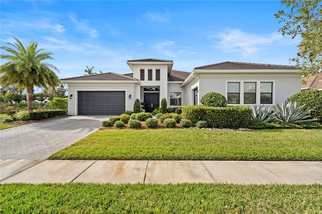 mediterranean / spanish-style home with a front yard and a garage