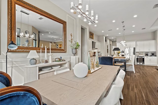 dining space with wine cooler and a chandelier