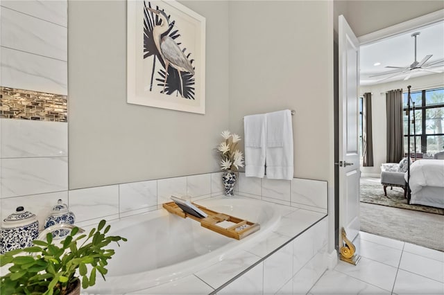 bathroom with ceiling fan and tiled tub