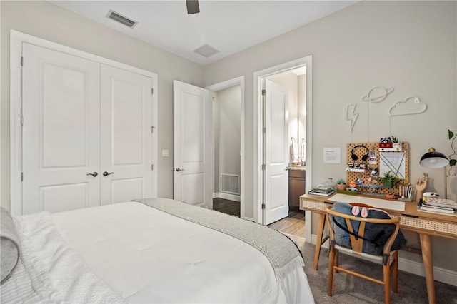 bedroom featuring connected bathroom, ceiling fan, a closet, and wood-type flooring